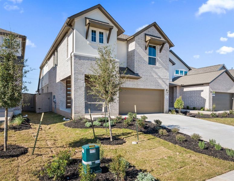 Front exterior of a new home in Flora, Hutto, TX, highlighting curb appeal (Image 22).