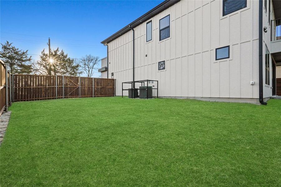 View of yard with a fenced backyard and cooling unit