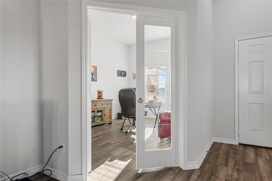 Home office with dark wood-type flooring