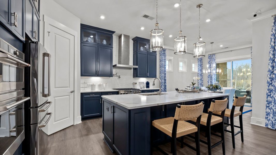 The Adventurer Plan by DBR Homes kitchen with blue cabinets and modern features in Fort Mill, SC.