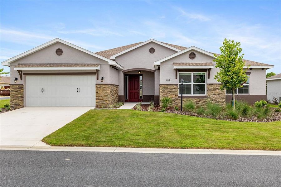 Front exterior of a new home in On Top of the World Communities, Ocala, FL, highlighting curb appeal (Image 1).