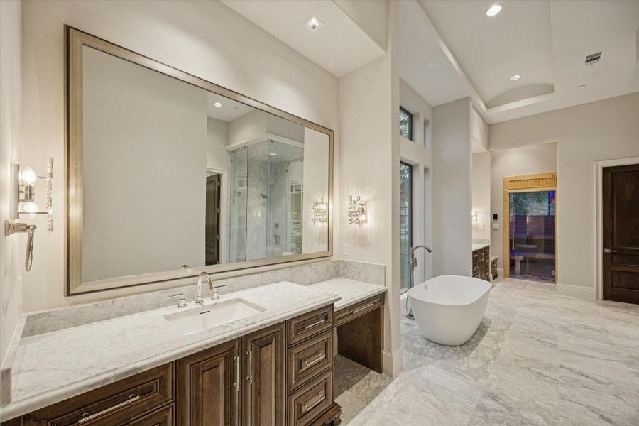 Spa-inspired primary bath featuring dual vanities, a freestanding tub, oversized walk-in shower, separate water closets, and designer finishes throughout. Spa-inspired primary bath featuring dual vanities, a freestanding tub, oversized walk-in shower, separate water closets, and designer finishes throughout.