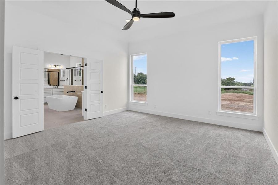 Spacious room featuring light gray carpeting and white walls Spacious room featuring light gray carpeting and white walls