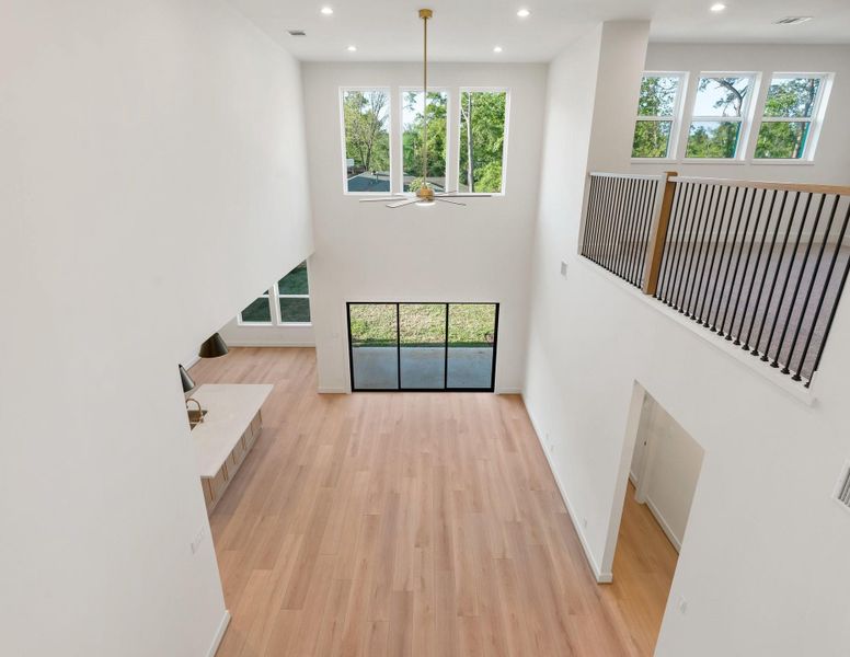 Gorgeous overlook of the living room from upstairs, highlighting the home’s open and airy design. Gorgeous overlook of the living room from upstairs, highlighting the home’s open and airy design.