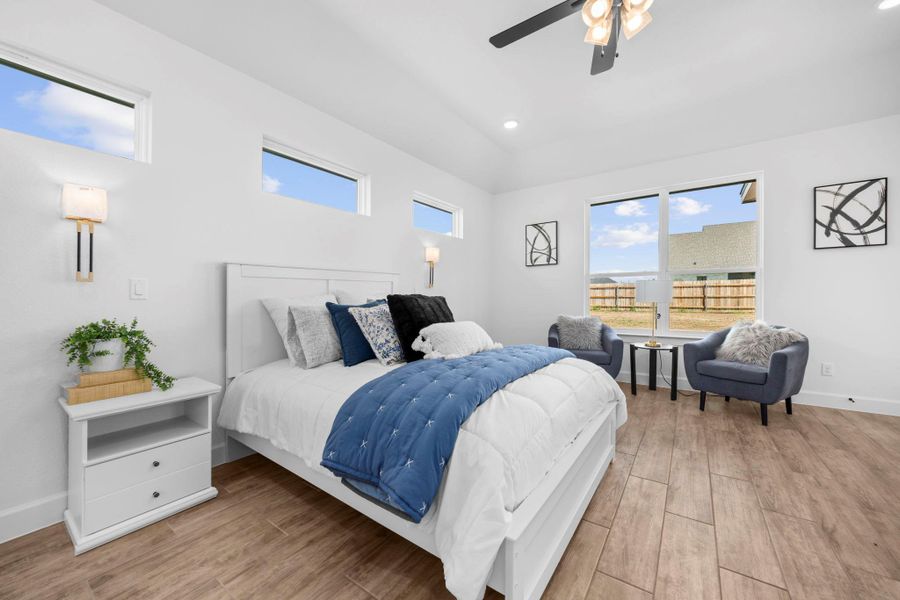 Bedroom with light wood-type flooring, ceiling fan, and recessed lighting
