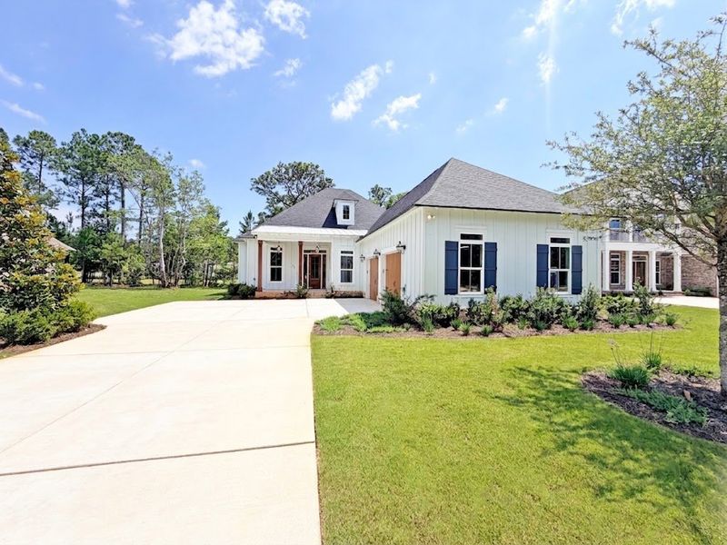 Front exterior of a new home in Steamboat Landing at Hammock Bay, Freeport, FL, highlighting curb appeal (Image 1). Front exterior of a new home in Steamboat Landing at Hammock Bay, Freeport, FL, highlighting curb appeal (Image 1).