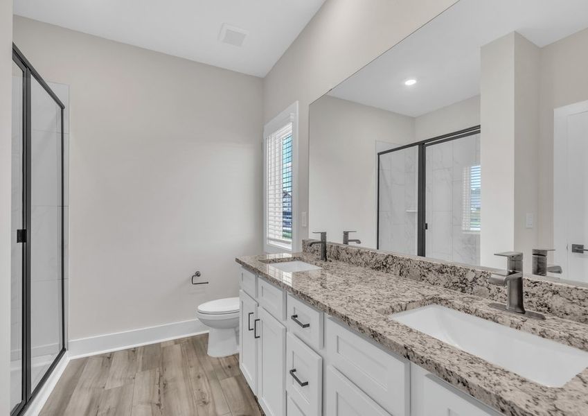 The master bathroom has double sinks and glass-enclosed shower. The master bathroom has double sinks and glass-enclosed shower.