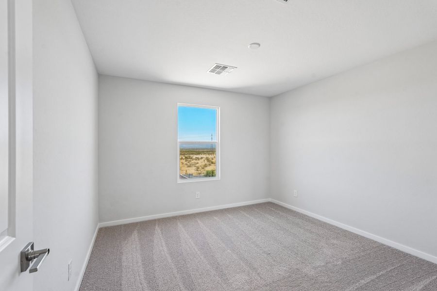 A room with a window and a carpet.