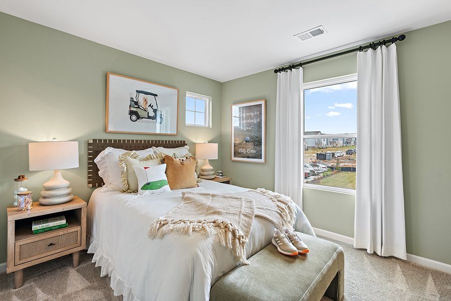 A bedroom with a large window. A bedroom with a large window.