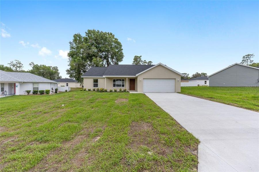 Front exterior of a new home in , Ocklawaha, FL, highlighting curb appeal (Image 2).