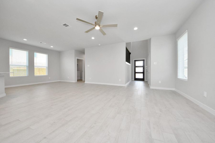 Gather the family and guests together in your lovely living room! Featuring soaring high ceilings, recessed lighting, ceiling fan, custom paint, gorgeous floors, and large windows that provide plenty of natural lighting throughout the day. Sample photo of completed home with similar floor plan. Actual colors and selections may vary. Gather the family and guests together in your lovely living room! Featuring soaring high ceilings, recessed lighting, ceiling fan, custom paint, gorgeous floors, and large windows that provide plenty of natural lighting throughout the day. Sample photo of completed home with similar floor plan. Actual colors and selections may vary.