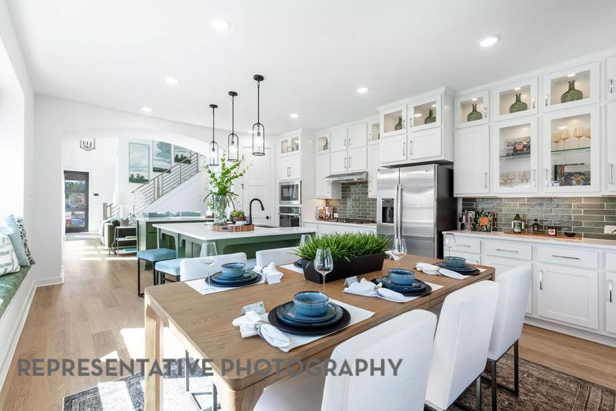 Dining room with light wood finished floors, arched walkways, and recessed lighting Dining room with light wood finished floors, arched walkways, and recessed lighting