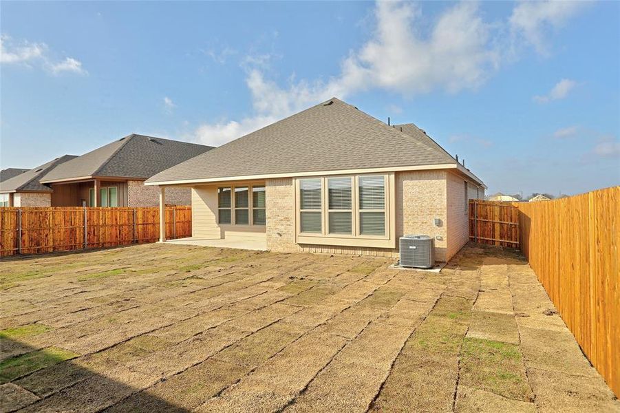 Rear view of property featuring cooling unit and a patio