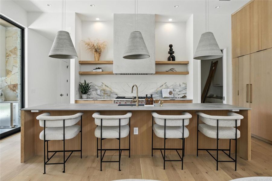 Kitchen with open shelves, modern cabinets, backsplash, and light countertops Kitchen with open shelves, modern cabinets, backsplash, and light countertops