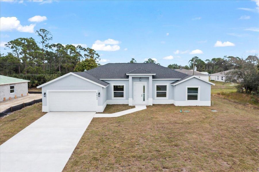 Front exterior of a new home in , Palm Bay, FL, highlighting curb appeal (Image 15). Front exterior of a new home in , Palm Bay, FL, highlighting curb appeal (Image 15).