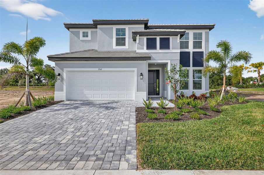Front exterior of a new home in Hawkstone, Sarasota, FL, highlighting curb appeal (Image 20).