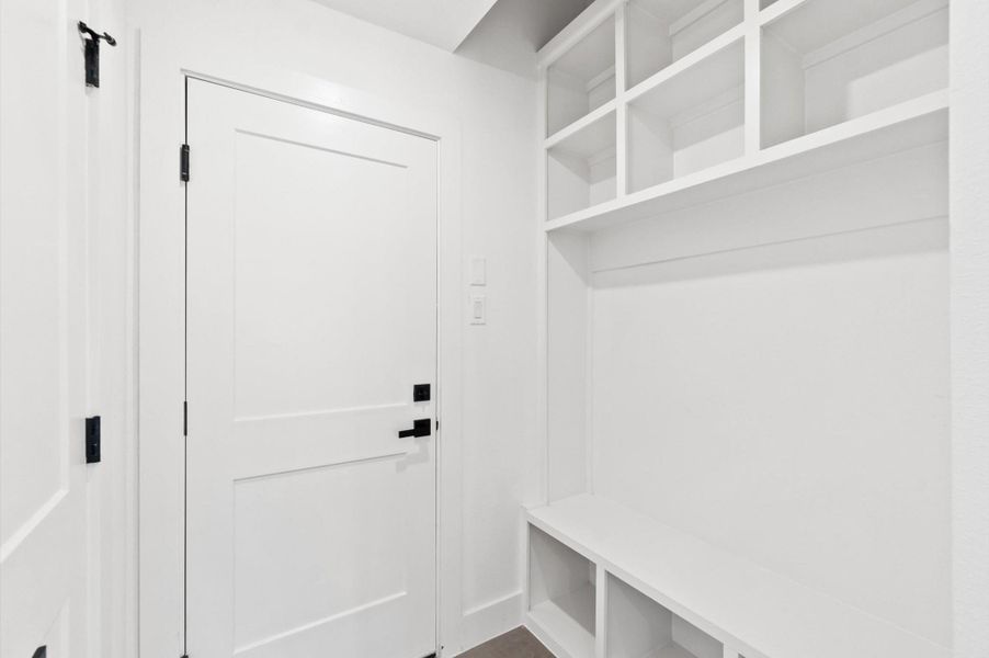Mudroom with custom built in cabinetry separating the kitchen and garage.*All photos are from the previous phase*