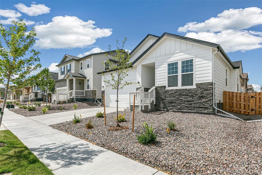 Front exterior of a new home in Turnberry, Commerce City, CO, highlighting curb appeal (Image 2). Front exterior of a new home in Turnberry, Commerce City, CO, highlighting curb appeal (Image 2).