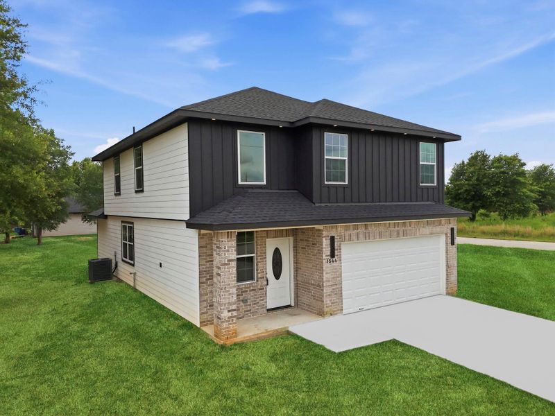 Front exterior of a new home in , Cleveland, TX, highlighting curb appeal (Image 33). Front exterior of a new home in , Cleveland, TX, highlighting curb appeal (Image 33).