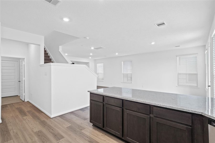 Additional view from kitchen looking towards hallway to laundry room, powder room, and staircase to second floor. Additional view from kitchen looking towards hallway to laundry room, powder room, and staircase to second floor.