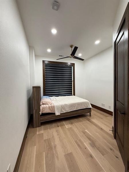Bedroom featuring light wood-type flooring, ceiling fan, and recessed lighting