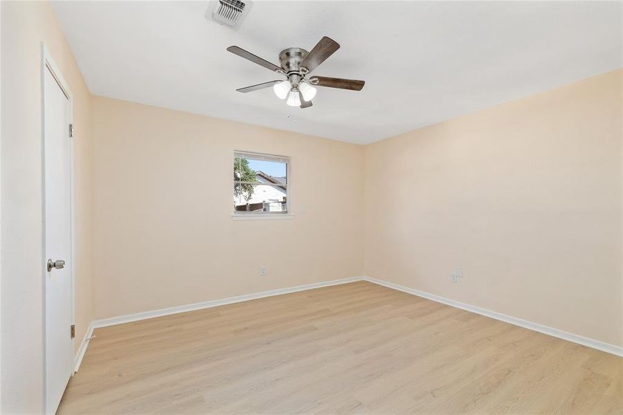 Unfurnished bedroom featuring light wood-style floors and a ceiling fan