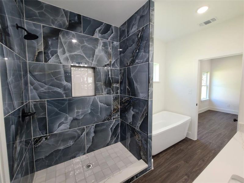 Bathroom with shower with separate bathtub and wood-type flooring