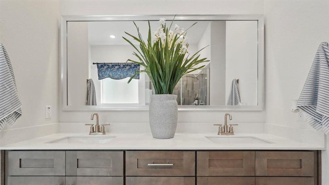 Double vanity featuring under-mount sinks and brushed nickel faucets