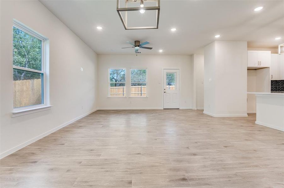 Unfurnished living room featuring recessed lighting, light wood-type flooring, and a ceiling fan