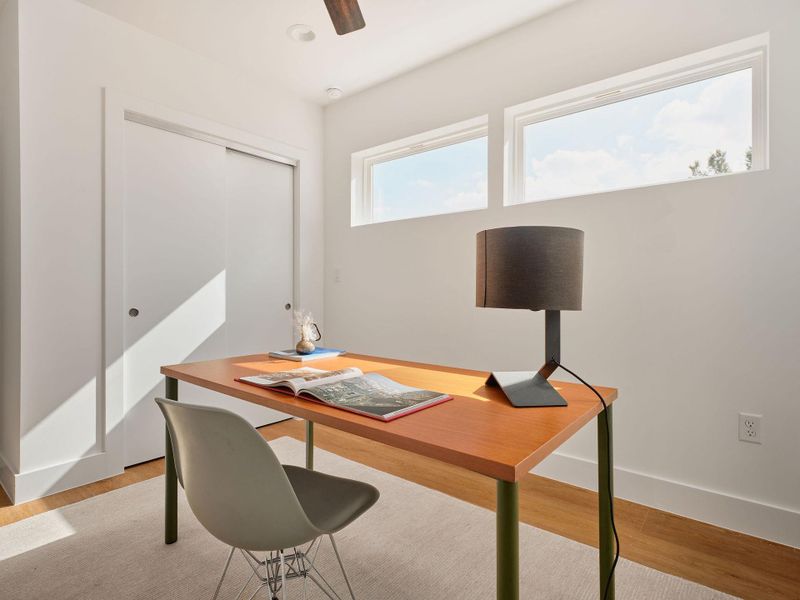 Home office with light wood-style floors and ceiling fan Home office with light wood-style floors and ceiling fan