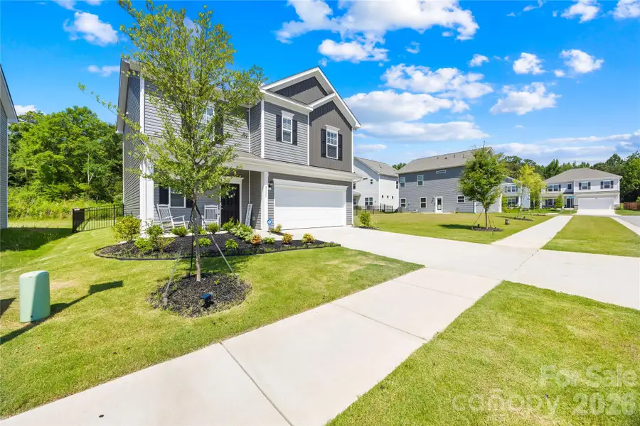 Front exterior of a new home in Orchard Creek, Charlotte, NC, highlighting curb appeal (Image 22).