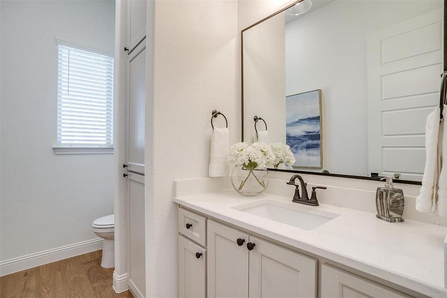 Powder bath with custom cabinetry and large vanity