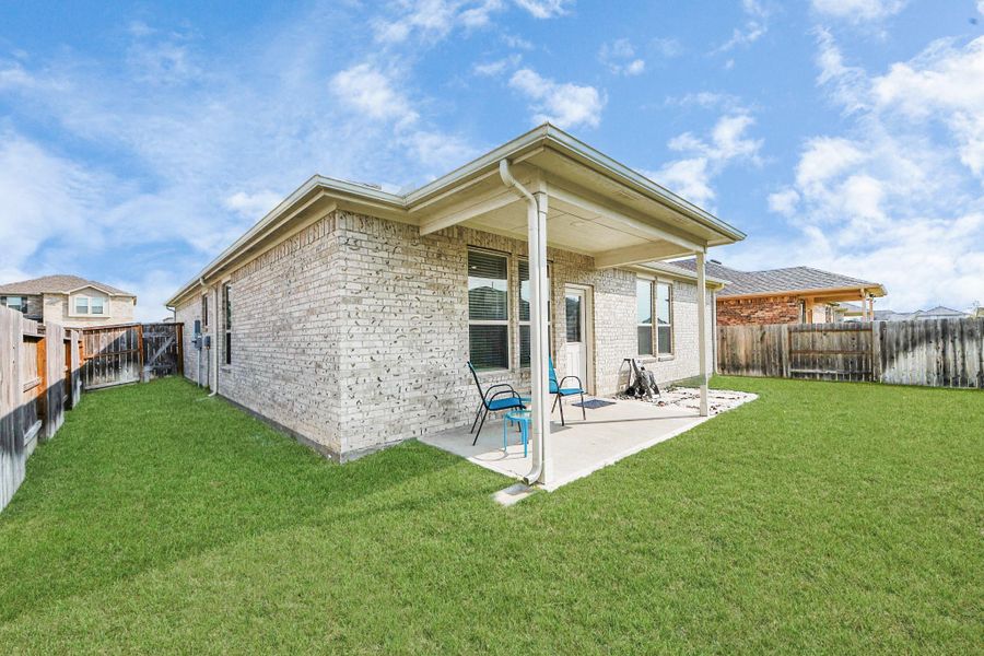 Large backyard space with covered back patio