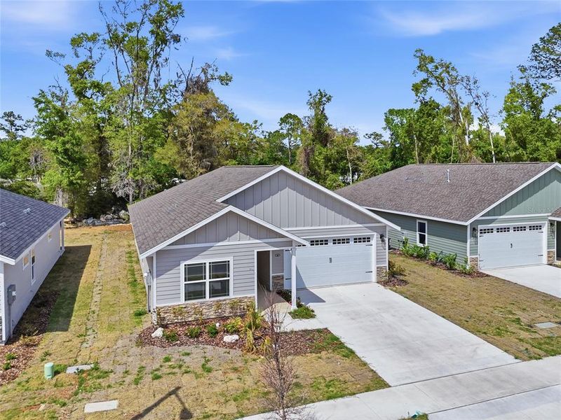 Front exterior of a new home in Grand Oaks, Gainesville, FL, highlighting curb appeal (Image 25).