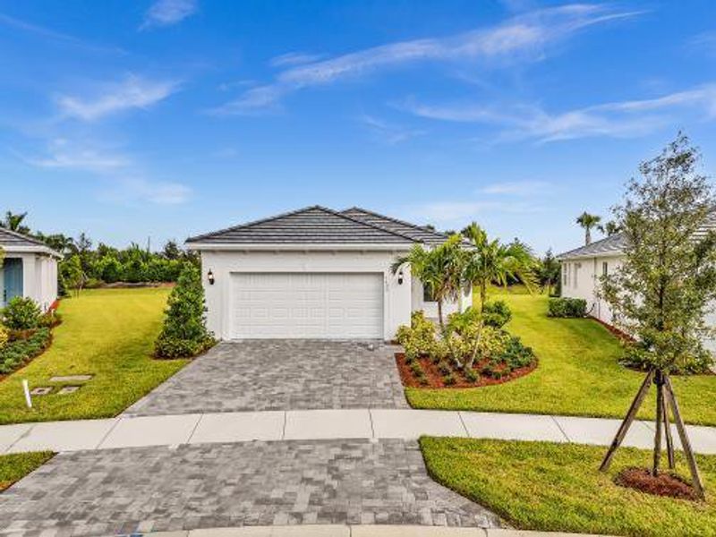 Front exterior of a new home in , Vero Beach, FL, highlighting curb appeal (Image 1). Front exterior of a new home in , Vero Beach, FL, highlighting curb appeal (Image 1).