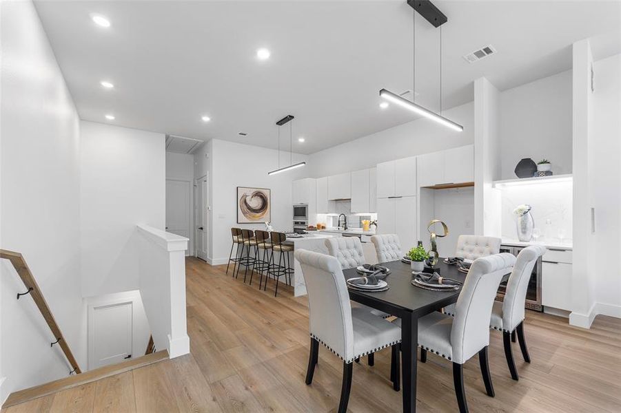 Dining area with light wood-style flooring and recessed lighting Dining area with light wood-style flooring and recessed lighting