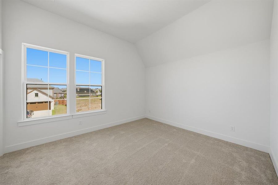 Bonus room with light colored carpet and lofted ceiling Bonus room with light colored carpet and lofted ceiling