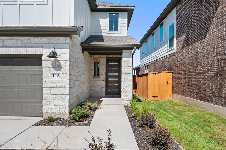 Front exterior of a new home in Terrace Collection at Lariat, Liberty Hill, TX, highlighting curb appeal (Image 2). Front exterior of a new home in Terrace Collection at Lariat, Liberty Hill, TX, highlighting curb appeal (Image 2).
