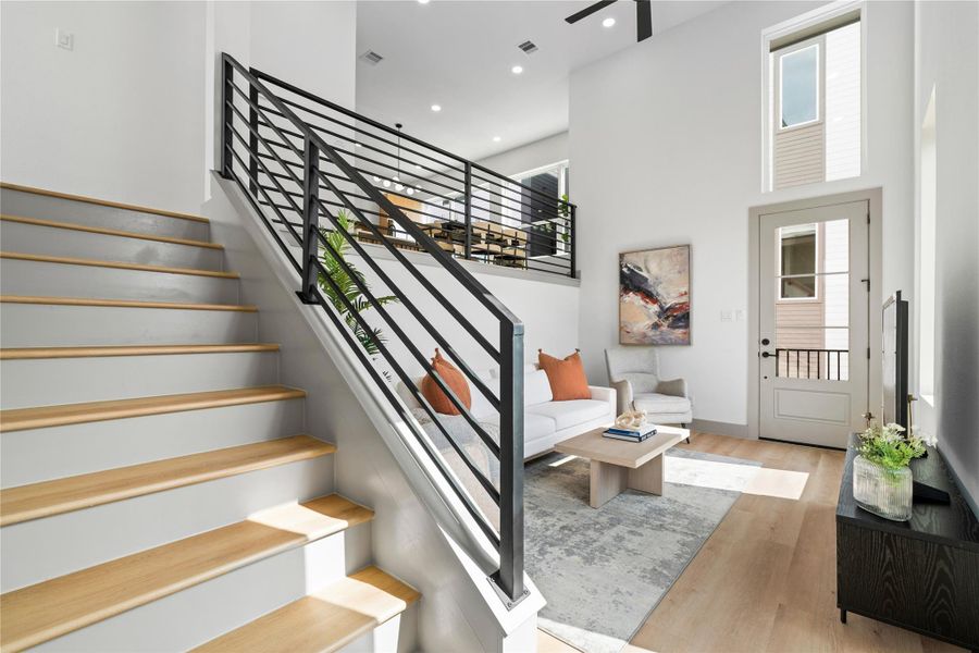 Soaring 18-ft ceilings and a modern split-level layout create an airy, elevated feel in this stylish living space—perfect for both relaxing and entertaining. Soaring 18-ft ceilings and a modern split-level layout create an airy, elevated feel in this stylish living space—perfect for both relaxing and entertaining.