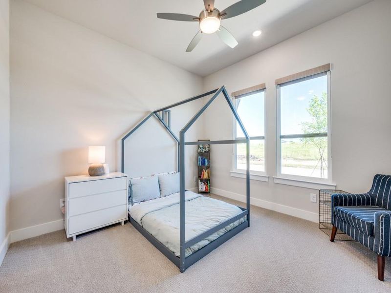 Carpeted bedroom featuring baseboards, ceiling fan, and recessed lighting