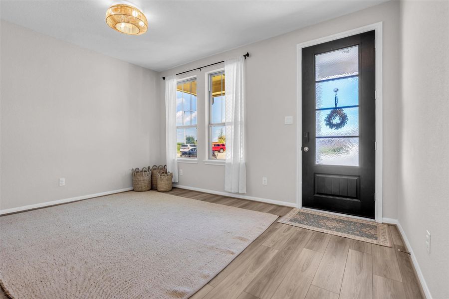 Positioned near the front entrance and overlooking the front lawn, it provides flexibility for a home office, sitting area, playroom, or other needs.