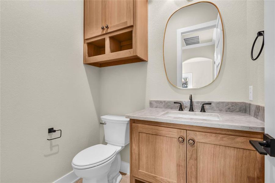 Bathroom with vanity and a textured wall