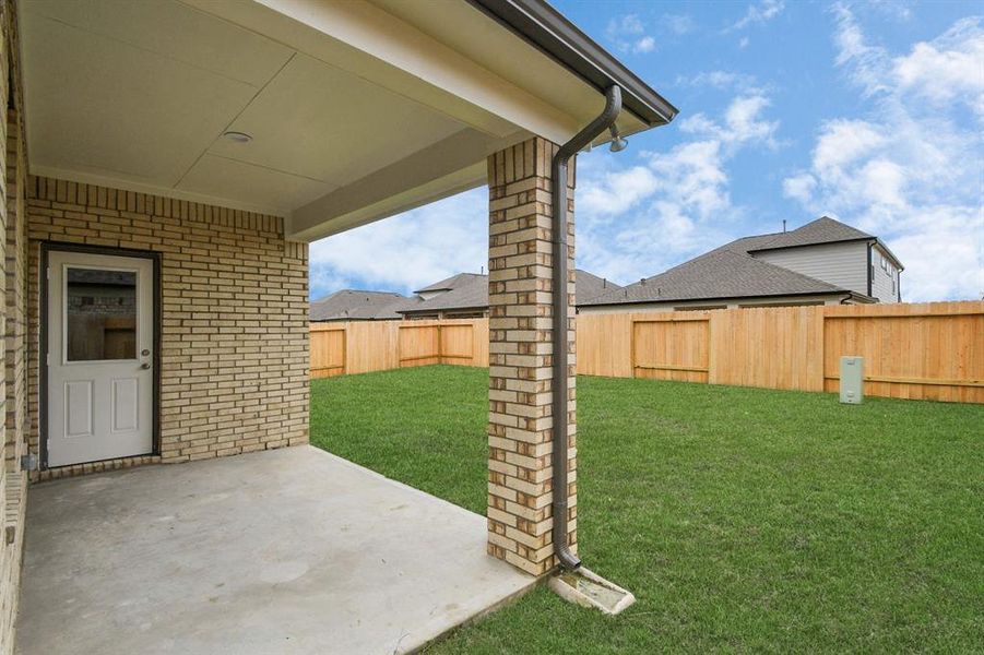 Experience outdoor living at its finest on this expansive covered patio, thoughtfully designed for BBQs and delightful outdoor dining