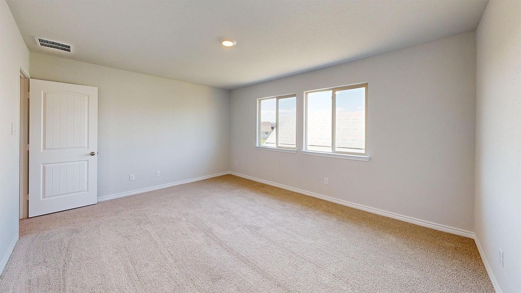 Spare room featuring light colored carpet and baseboards Spare room featuring light colored carpet and baseboards