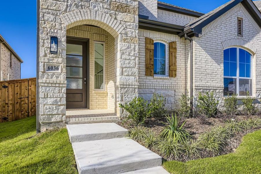 Doorway to property with brick siding and stone siding
