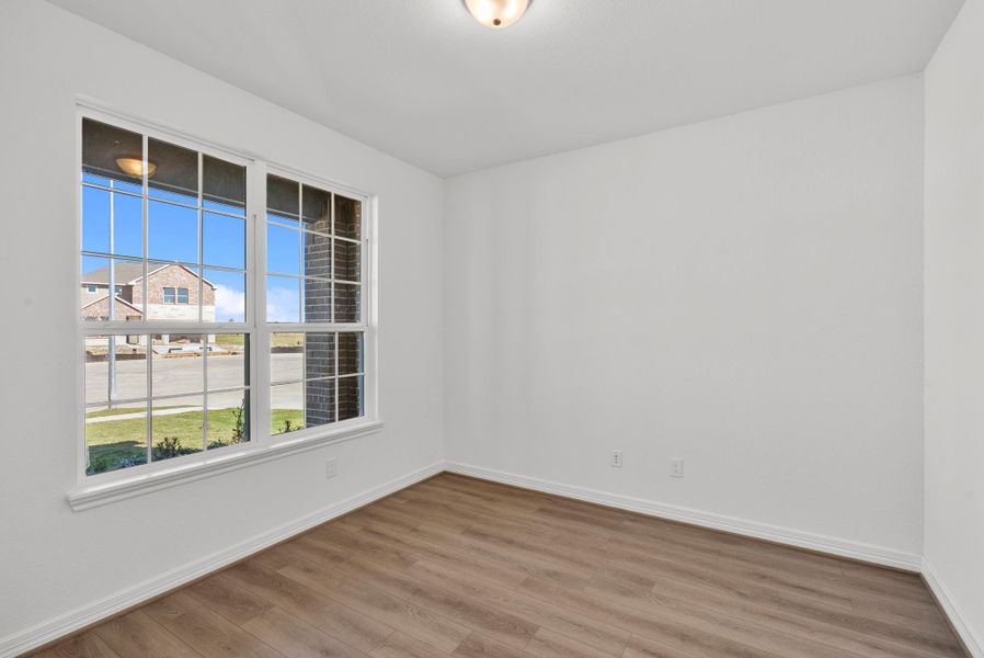 Expansive study with ample space and a serene view of the front yard—perfect for work, reading, or quiet reflection.