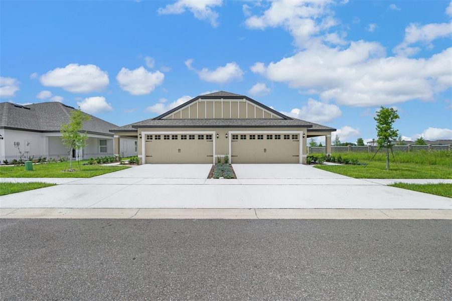 Front exterior of a new home in Gum Lake Preserve, Lake Alfred, FL, highlighting curb appeal (Image 18).