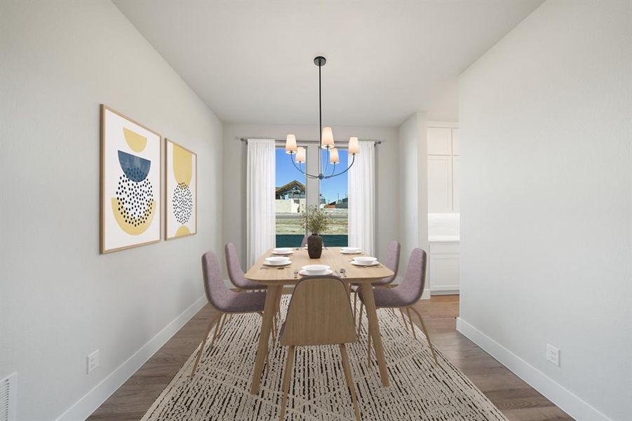 Dining room featuring a chandelier and wood finished floors Dining room featuring a chandelier and wood finished floors