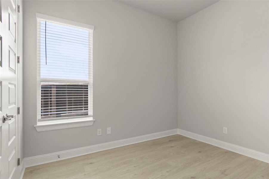 Empty room with wood finished floors and baseboards