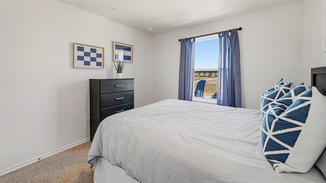 Bedroom with carpet flooring and baseboards Bedroom with carpet flooring and baseboards